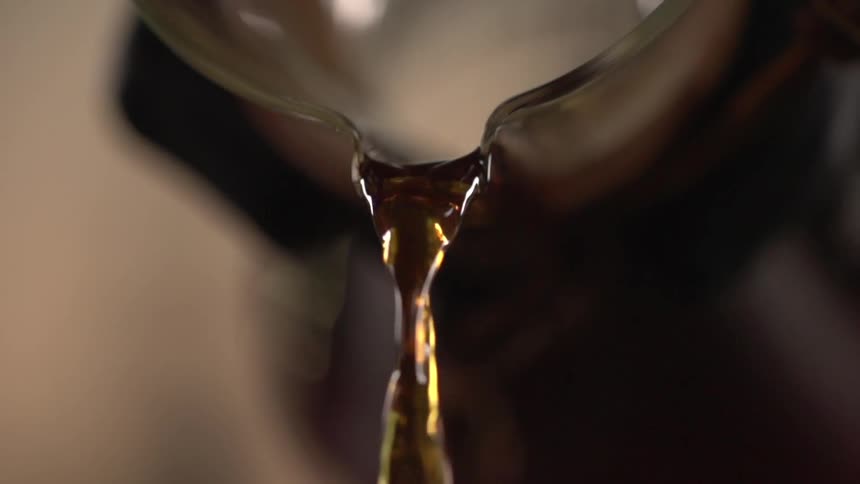 Coffee being poured from a glass carafe