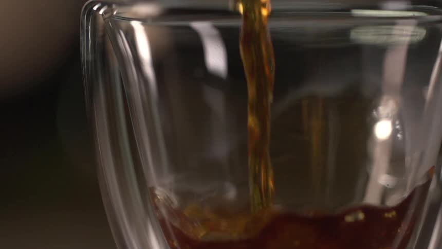 Amber colored liquid pouring into glass