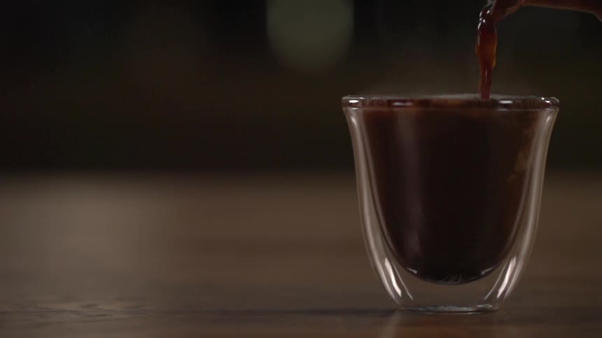 A beverage being poured in a cup for a photo shoot