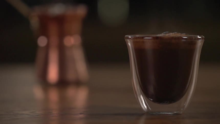 A cup of coffee sitting on a counter