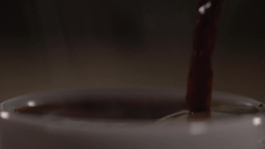 A beverage being poured in to a glass