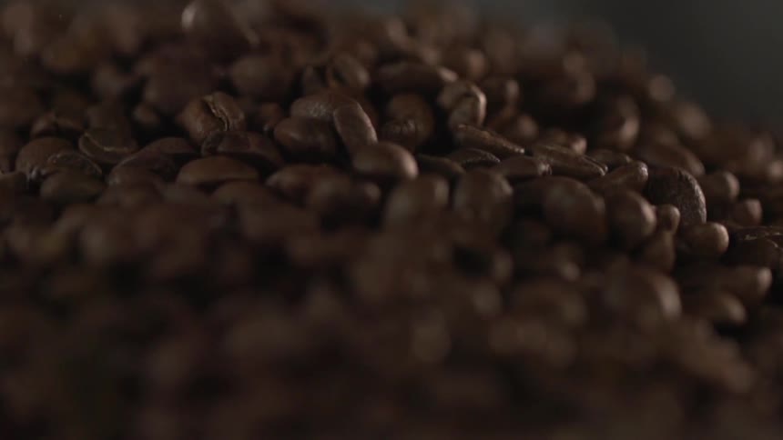 A large pile of coffee beans in a factory