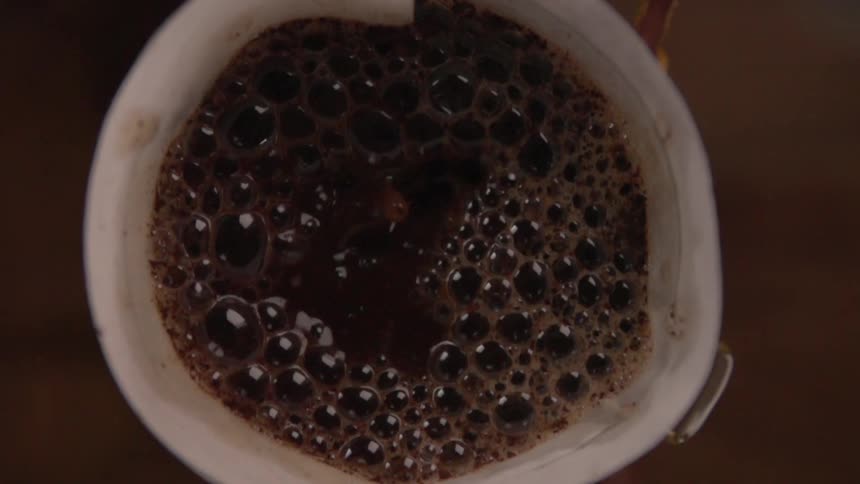 Coffee being poured into a white cup
