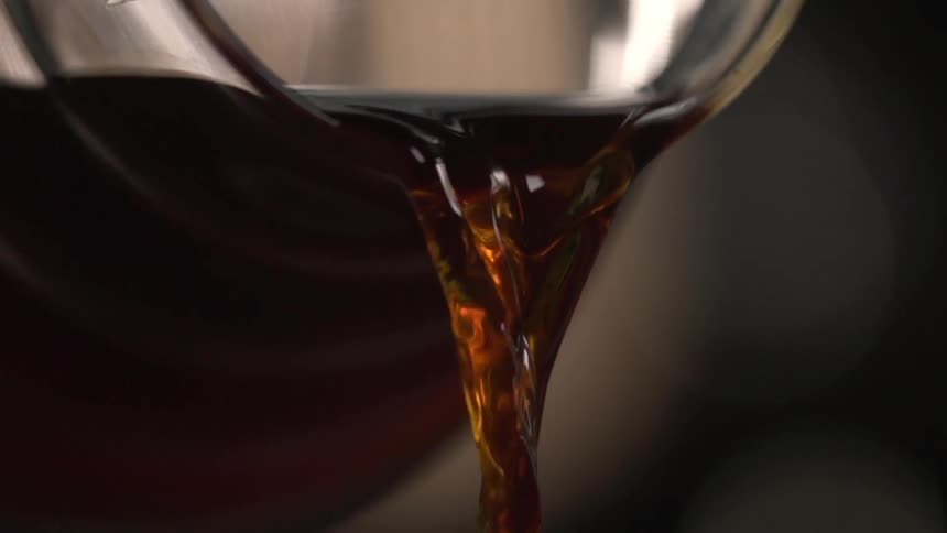 Coffee pours out of a pitchers spout