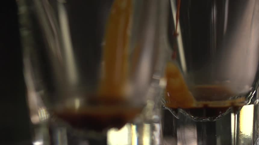 A thick brown liquid fills two glass containers