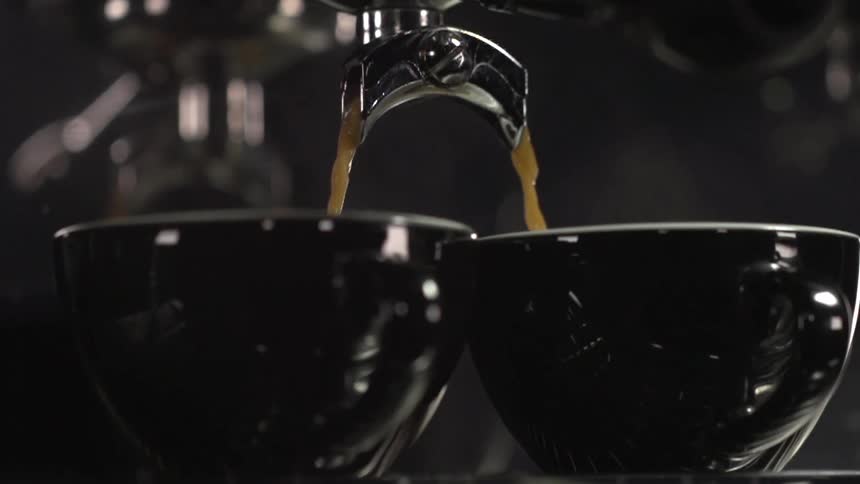 Liquid is being poured into two bowls at a restaurant