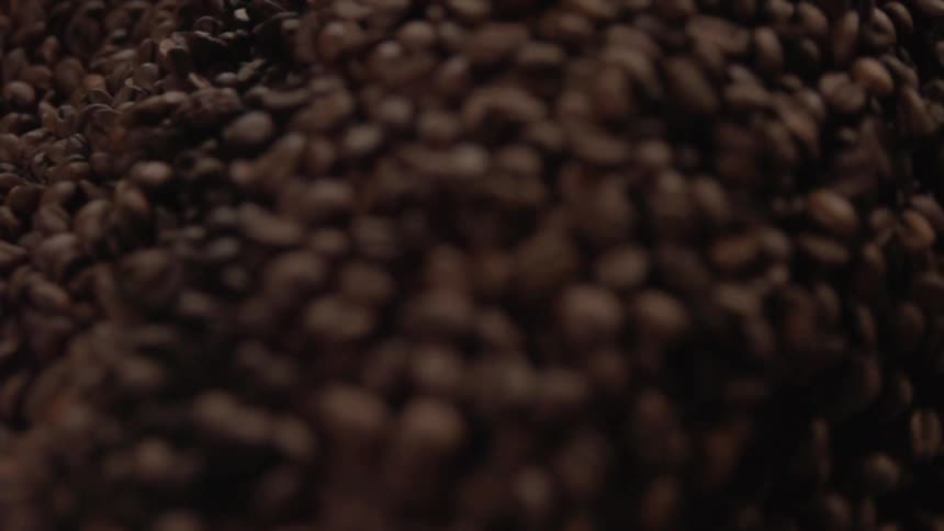 Coffee beans being stirred by a machine