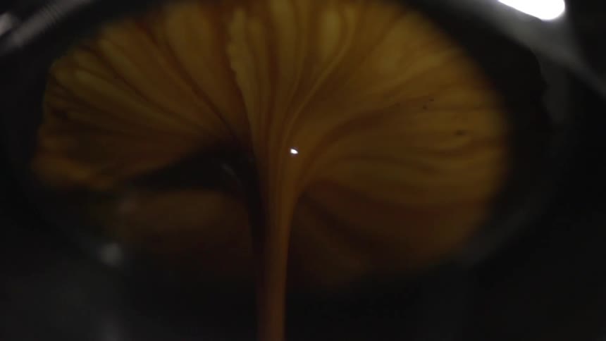 Flowing stream of brown liquid