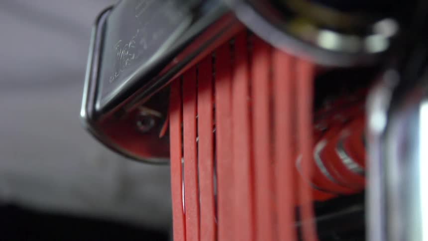 A machine slices strips of a food product