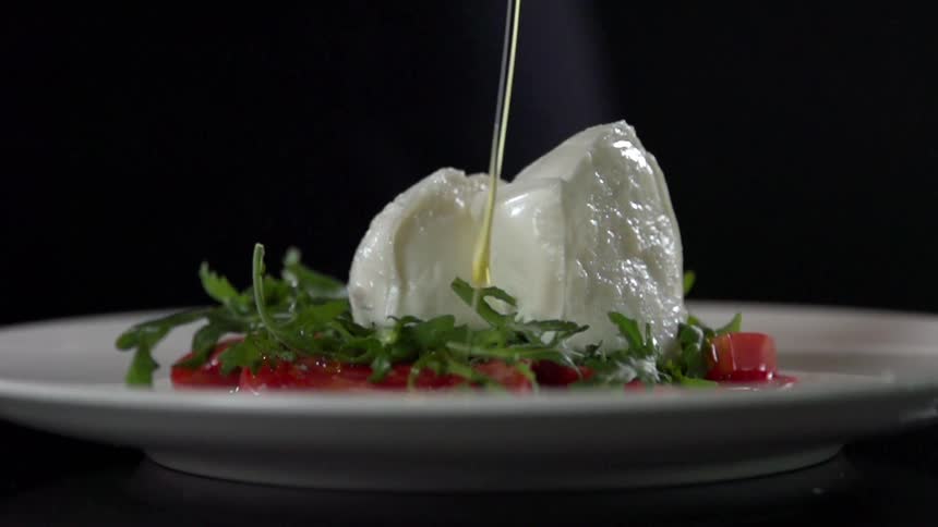 Oil being poured on food for a photo shoot