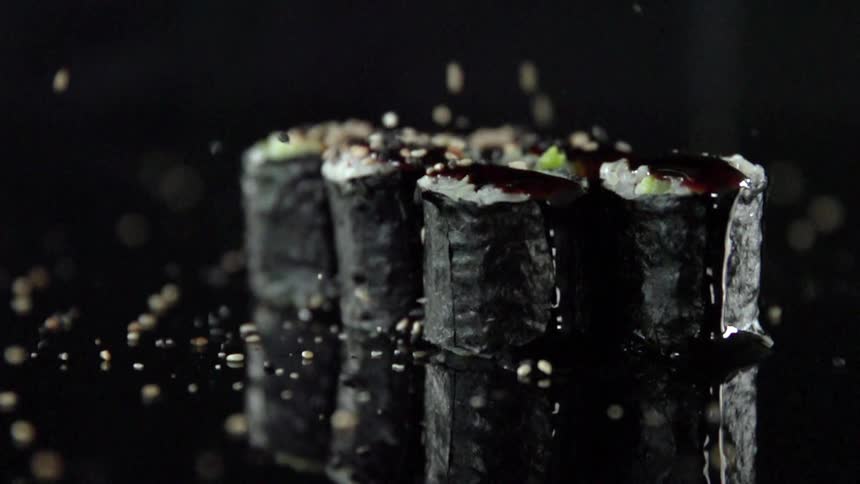 Seasonings bounce off rolls of sushi