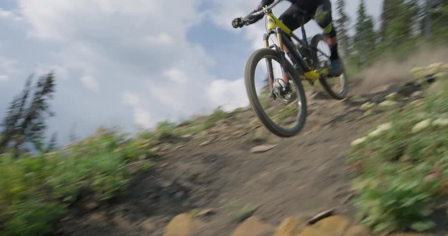 A mountain bike rider descends a steep trail in the alpine 2
