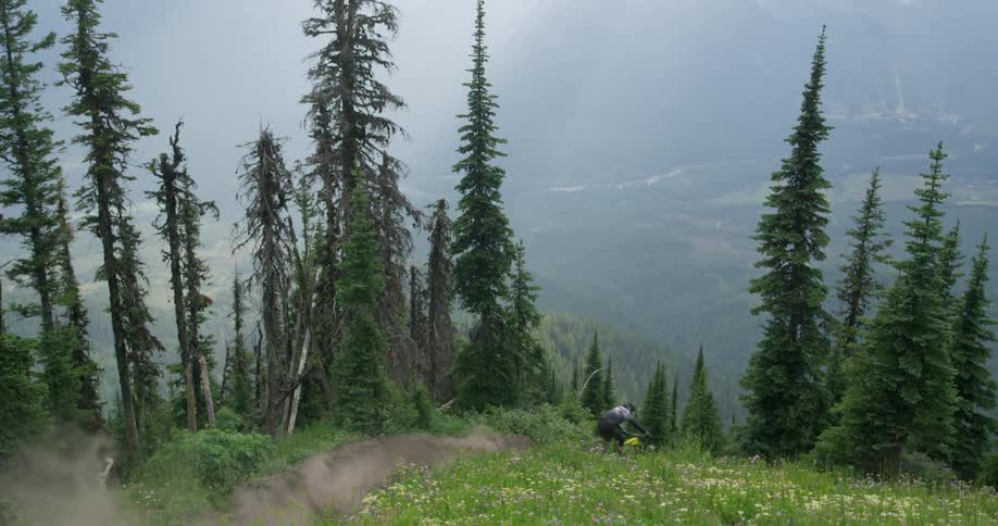 A mountain bike rider descends a steep trail in the alpine 3