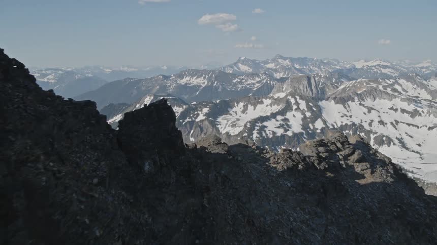 An aerial view of snowy mountains in the wilderness