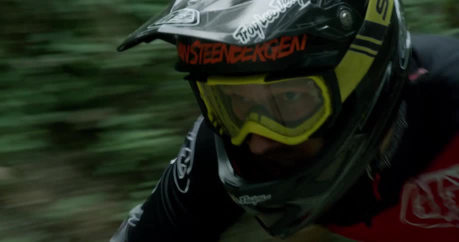 Tight Shot of Downhill Mountain Biker Goggles In A Forest At Speed