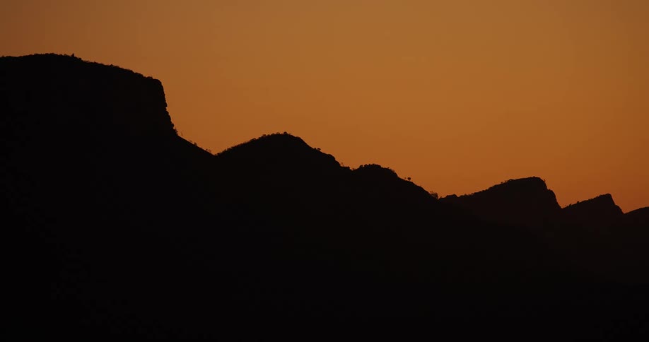 Mountains sit under the red sky