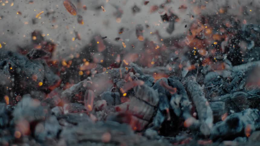 Embers and ashes from a fire fly through the air