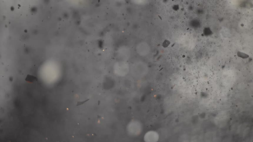 Embers and ash fly through the air