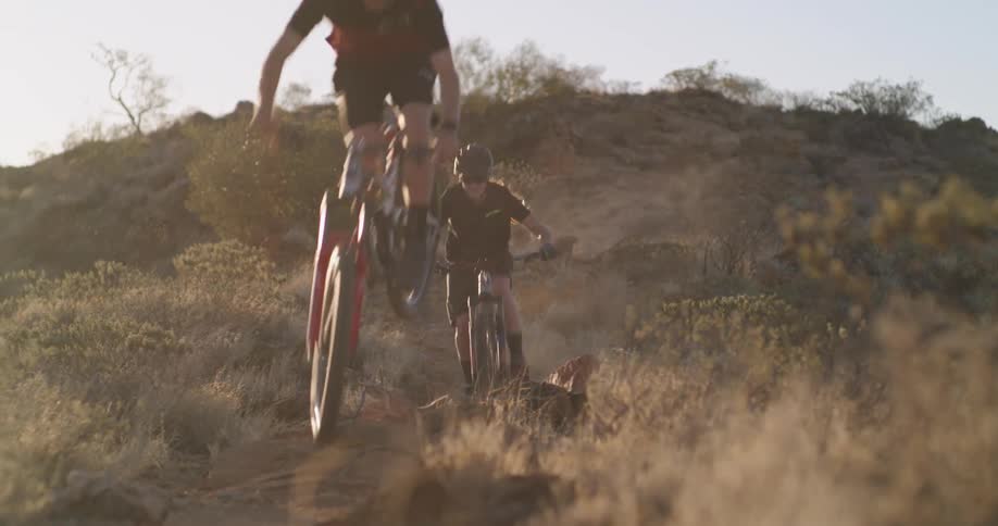 Two young athletes riding through the desert on mountain bikes