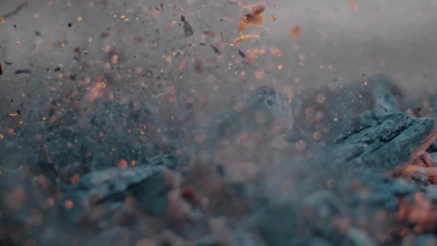 Ashes and embers from a fire around in the air