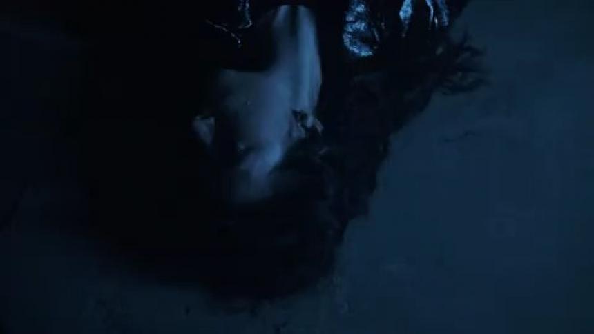 Woman laying on ground under strong strobe effect
