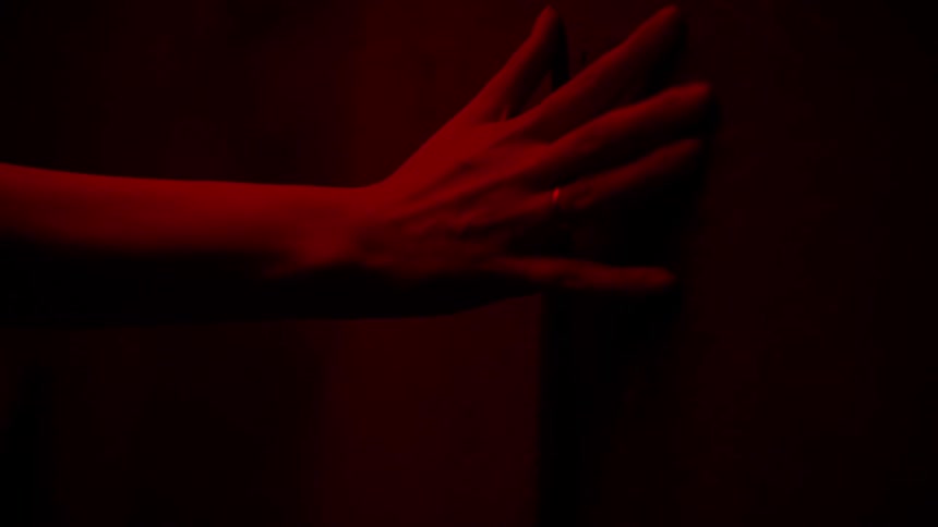 A woman reaches her hand forward