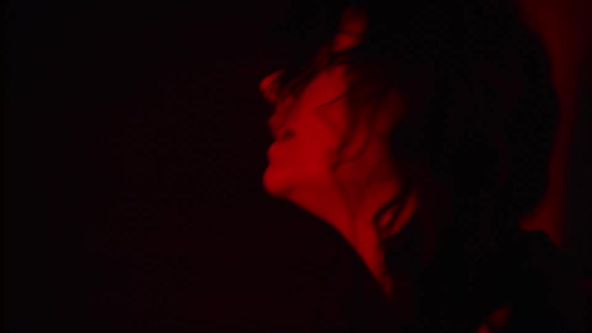 A woman sings indoors