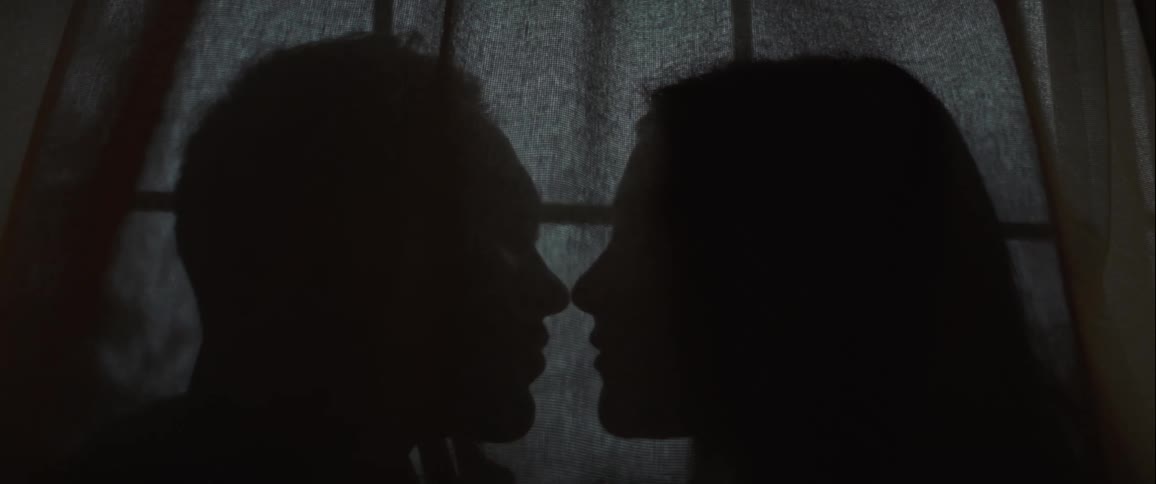 A man and woman kiss