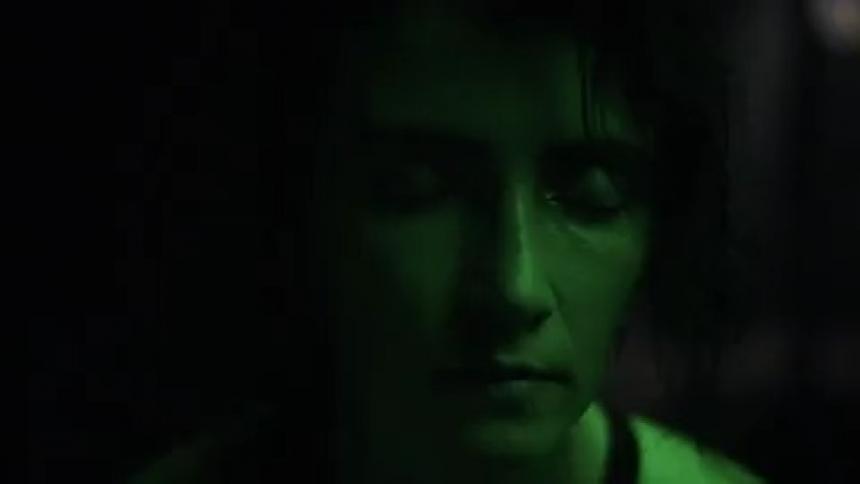 A person staring with lights flashing on their face then they close their eyes