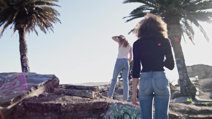 Woman walk across walks and head towards other people