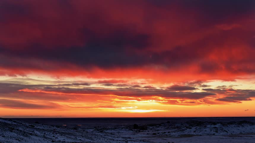 The sun below the horizon off the coast