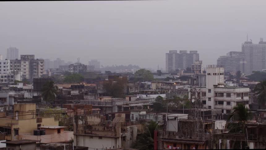 A slum sits near a downtown area in the third world