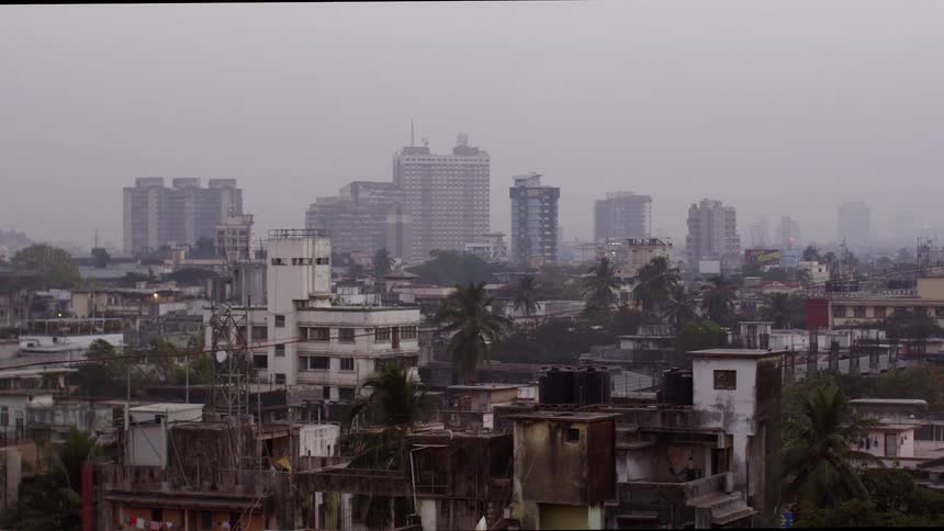 Urban neighborhood in developing country with skyline under fog