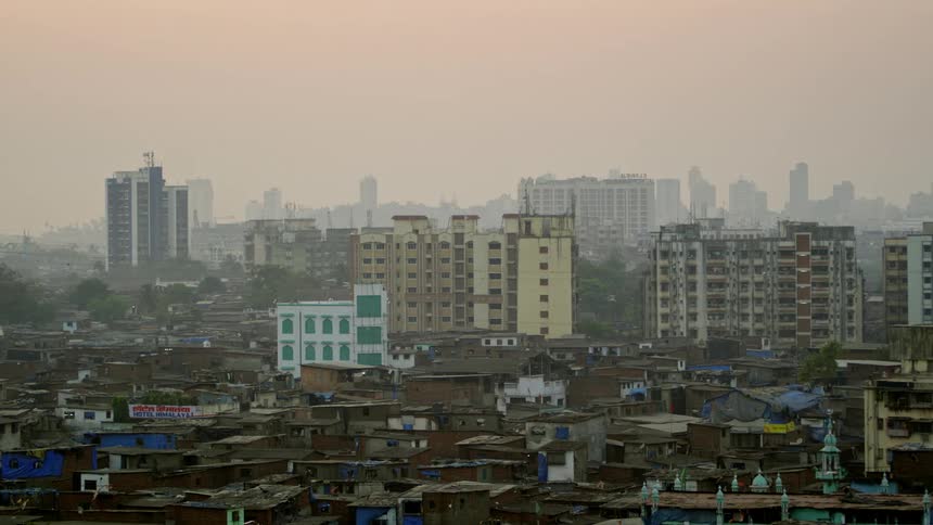 Smog enshrouds a city skyline and a shanty neighborhood