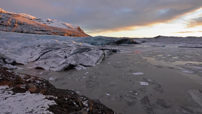 A body of water and rocks frozen during winter