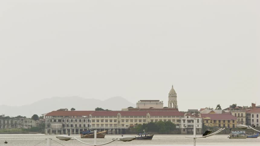 A campus on the shore with boats on the water