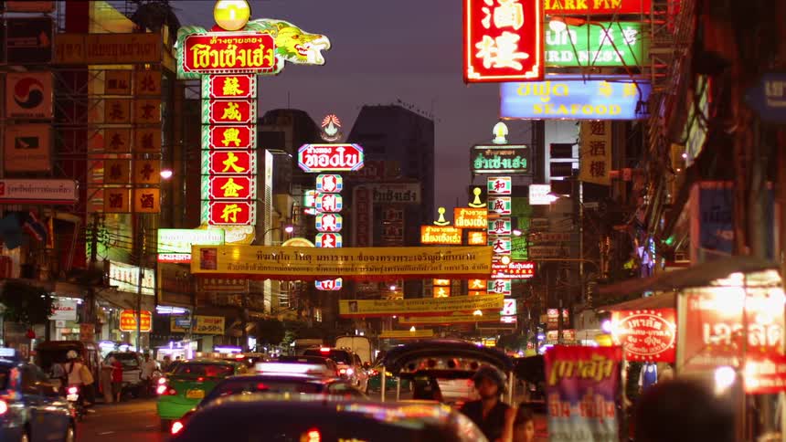 A busy downtown area is illuminated at night