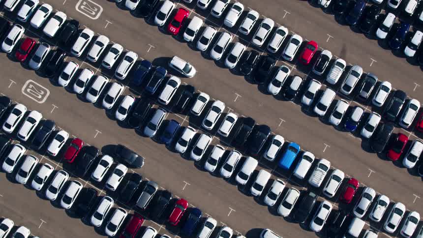 Aerial of parking lot filled with parked cars