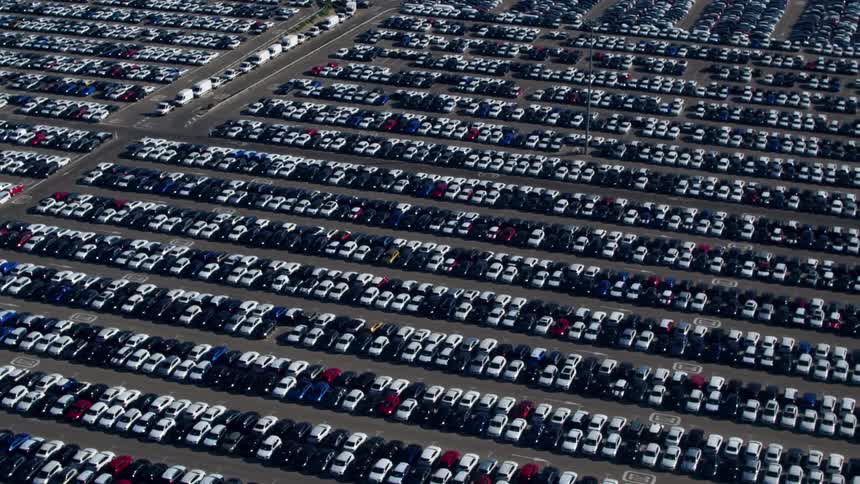 Cars parked in neat rows in a very large lot