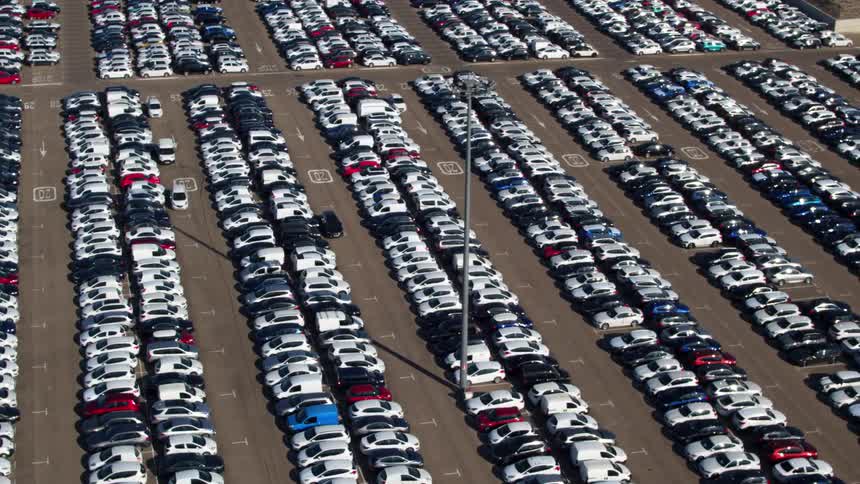 A parking lot is filled with hundreds of vans cars trucks and suvs