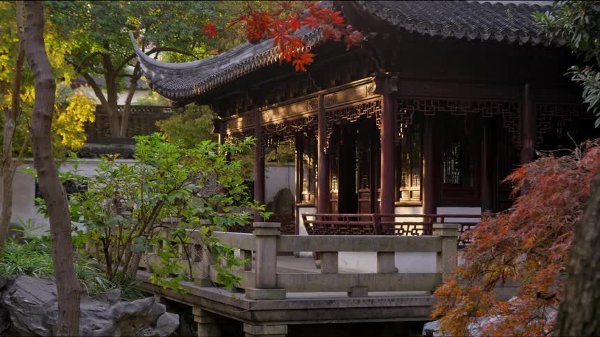 Sun dapples asian style building and trees with autumn foliage