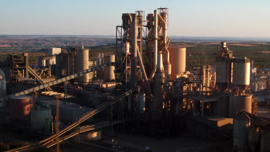 A large factory lies in the middle of a plains area