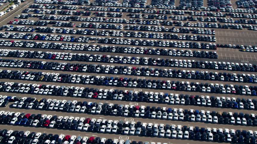 Aerial shot of massive parking lot filled with vehicles