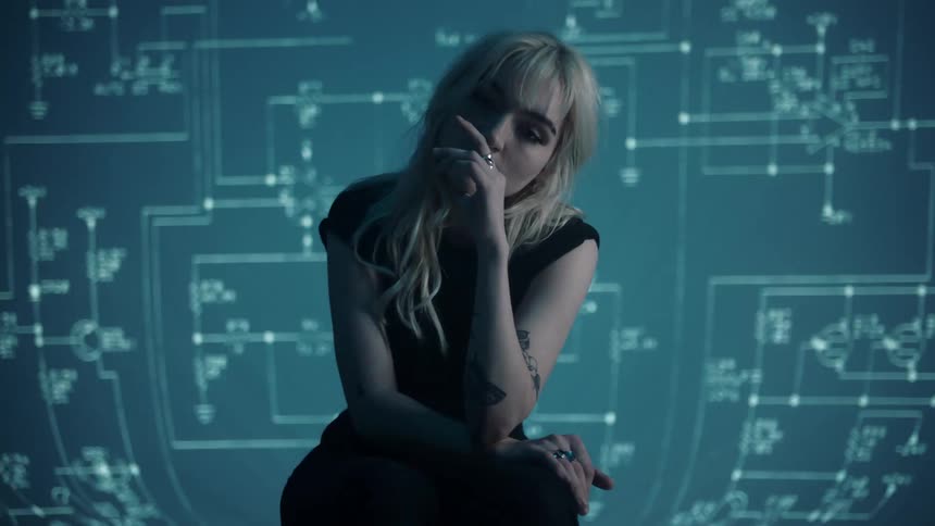A teenager sits in front of a flashing screen for a photo shoot