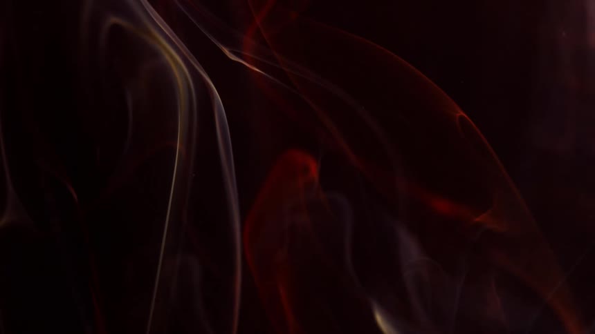 Red and yellow smoke swirling against black background