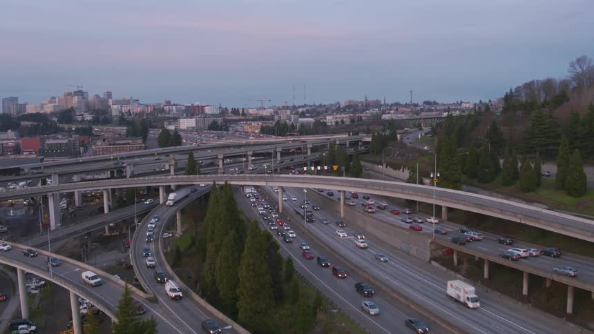 Traffic starts to build at evening rush hour on a busy urban highway interchange