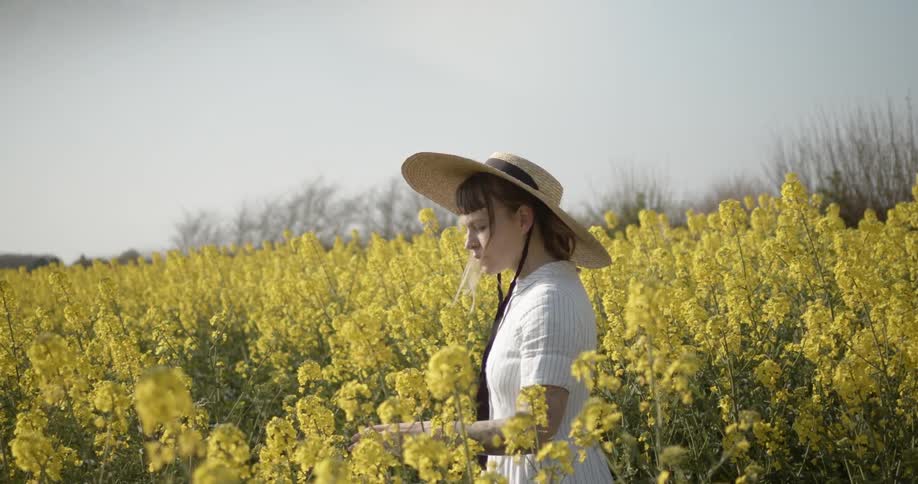 A teenager stands in a field of flowers