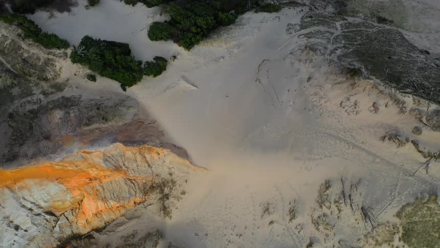 Aerial view of a canyon and sandy soil next to it