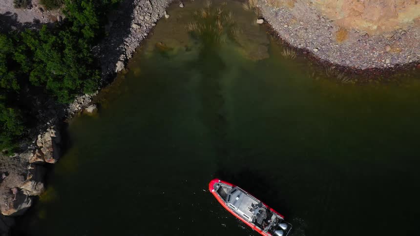 A boat floats on a small pond