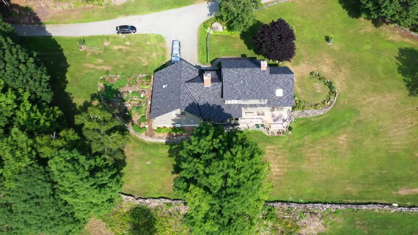 A large home sits on a large piece of property out in the sticks